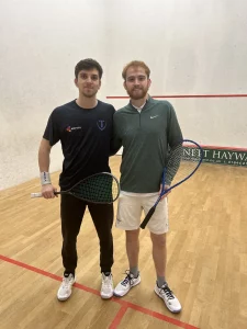 Male squash players standing on court